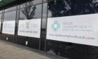 Signs at Dundee's Dock Street advertising the opening of Tayside Complete Care, a new eye care clinic opening in winter 2025.