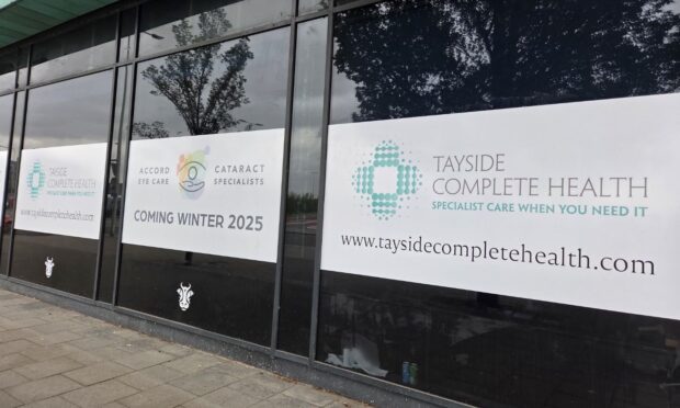 Signs at Dundee's Dock Street advertising the opening of Tayside Complete Care, a new eye care clinic opening in winter 2025.