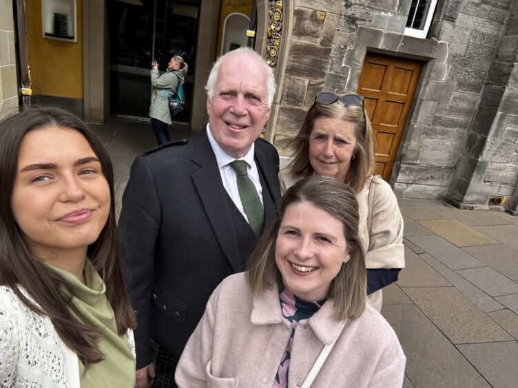 Andrew, Maxine, Angel and Emily Scott taking selfie in front of palace
