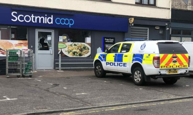 Police outside the Scotmid Co-op shop in Invergowrie on Tuesday. Image: James Simpson/DC Thomson
