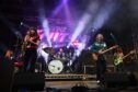 The Zutons performing on stage.