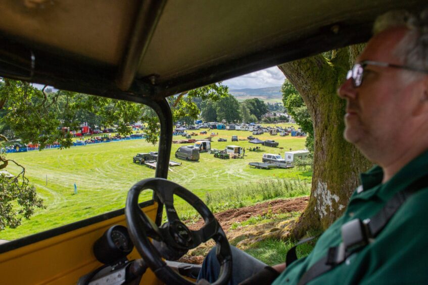 A view from inside a Land Rover looking out at some of the vehicles on show.