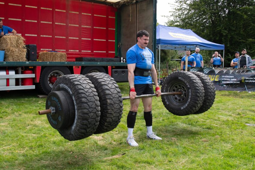 A man deadlifts a huge weight during the Braco's Strongest Man competition.