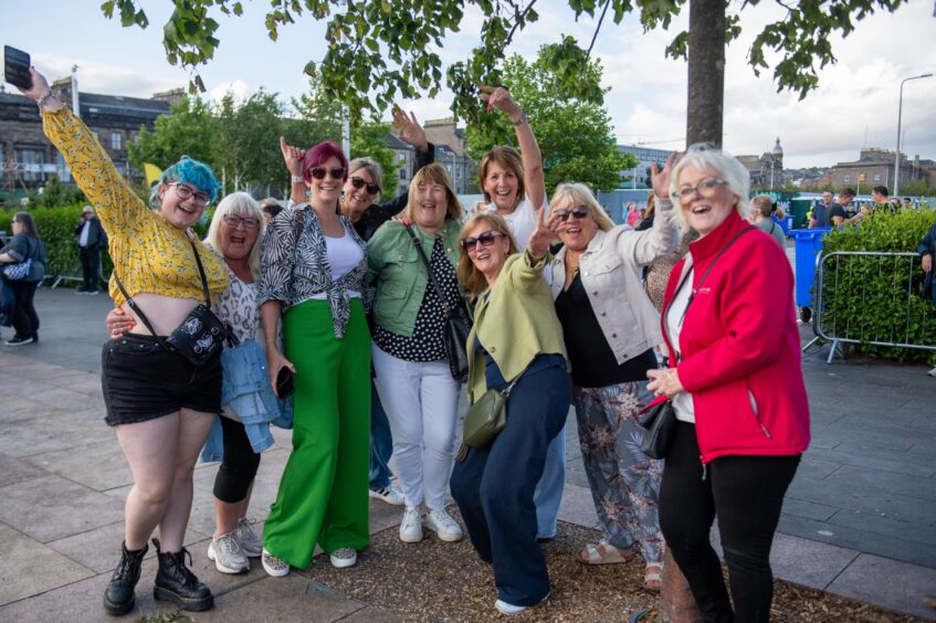 A group of fans wave to the camera ahead of seeing Tom Jones at the Discovery Festival.