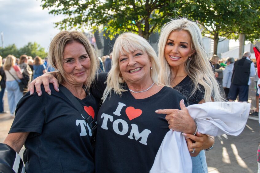 Three women showing their love for Tom Jones in Dundee.