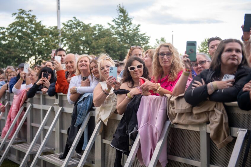 Fans snapping pictures of Tom Jones in action.