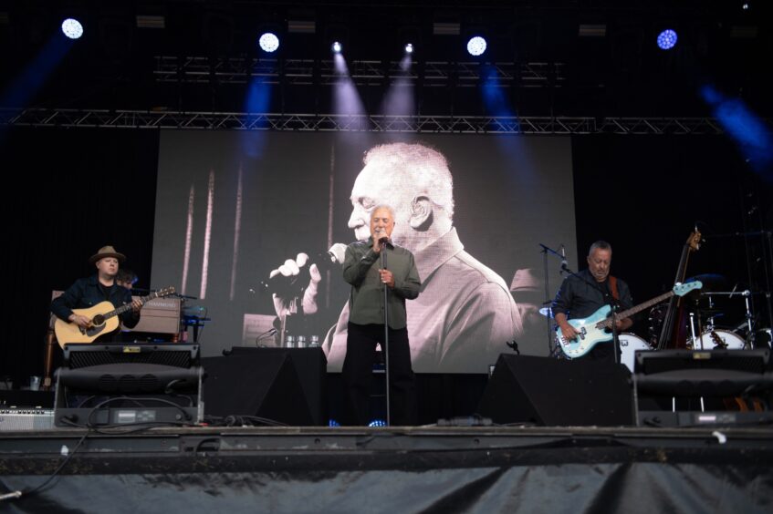 Tom Jones and his band on stage in Dundee.