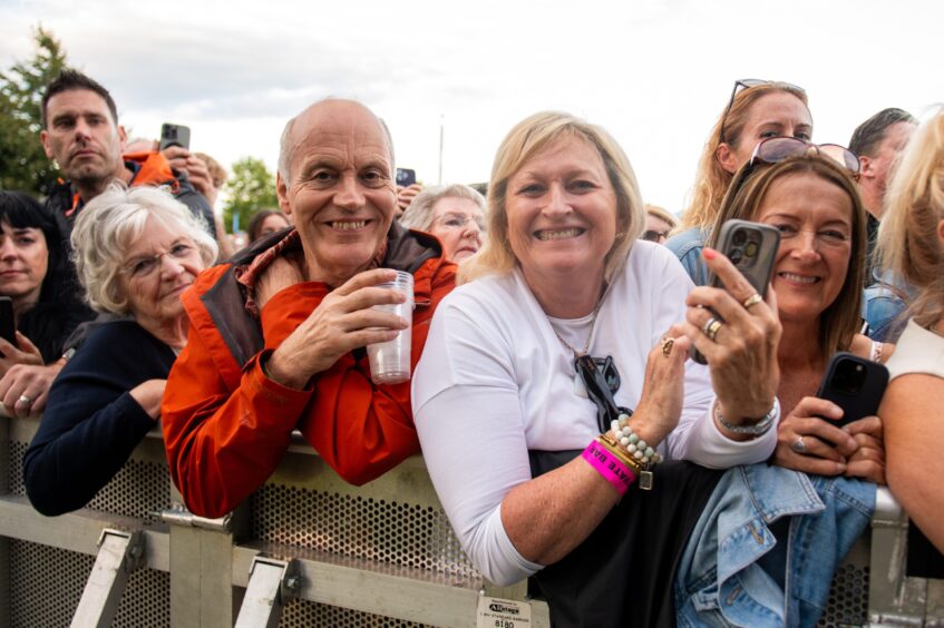 Happy fans enjoy the Tom Jones performance.
