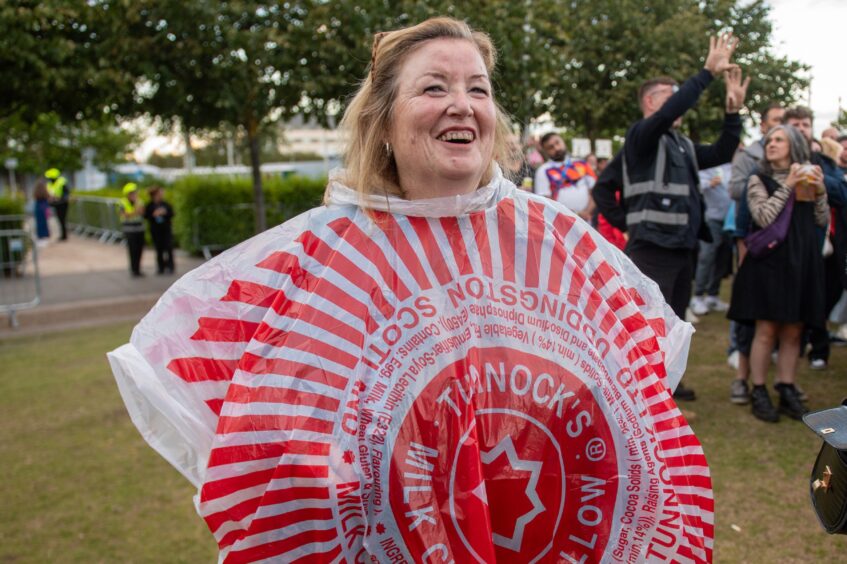 A woman wearing a plastic rain jacket. 