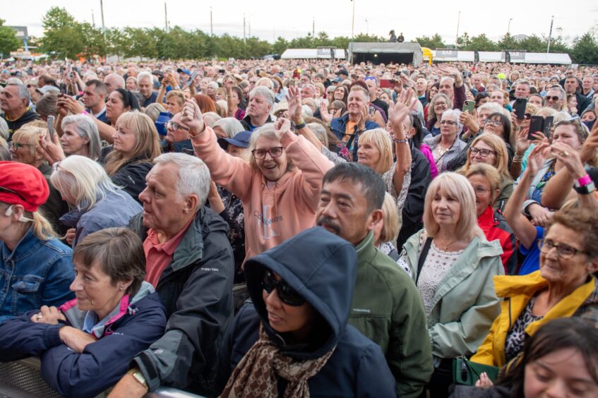 Fans stand in wait for Tom Jones to arrive on stage in Dundee.