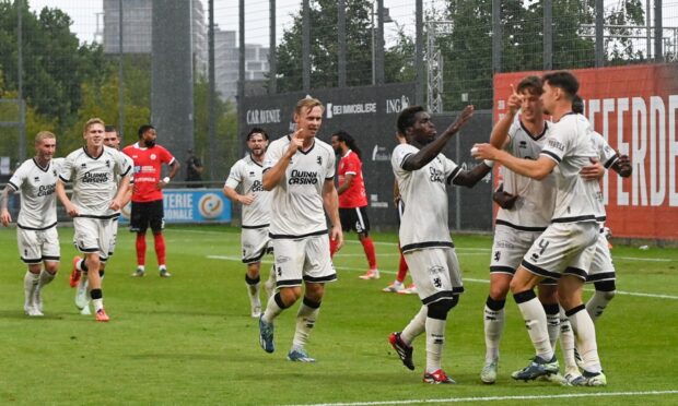 Dundee United players celebrate the nerve-settling decider.