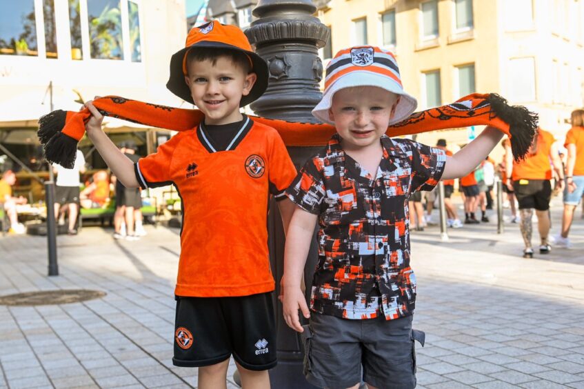 Young United fans Daniel Low and Noah Thomson show off their team's colours.