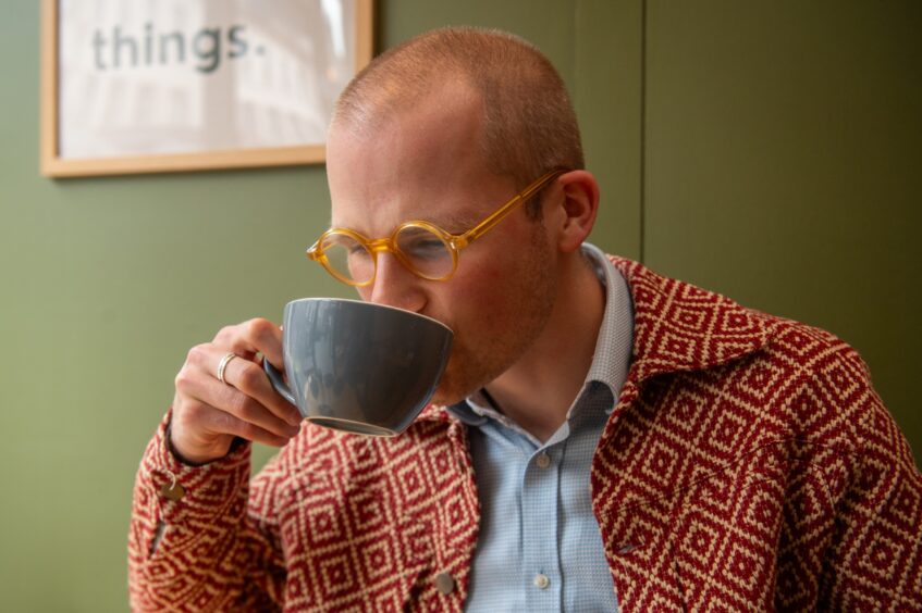 Jacob Smith drinking a matcha latte.
