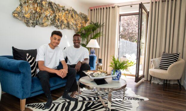 Howey Ejegi with son Jai at home in Dundee. Image: Kenny Smith/DC Thomson