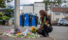 Mourner Kudzai Campbell lays flowers at South Road Image: Kenny Smith/DC Thomson
