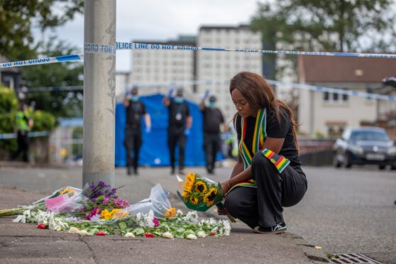 Mourner Kudzai Campbell lays flowers at South Road Image: Kenny Smith/DC Thomson