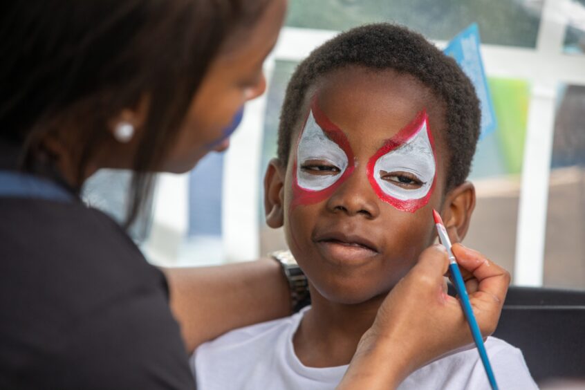Close-up of Nicholas Essien, age 6, having his face painted at the Afro-Caribbean Summer Festival in Dunfermline.