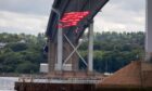 Greenpeace protestors hanging from under the Forth Road Bridge. Image: Kenny Smith/DC Thomson