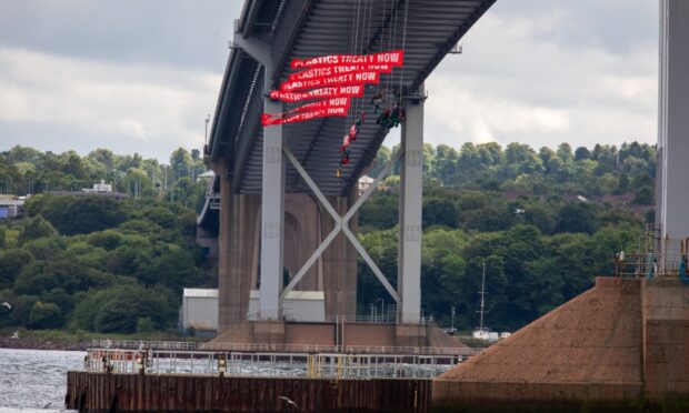 Greenpeace protestors hanging from under the Forth Road Bridge. Image: Kenny Smith/DC Thomson