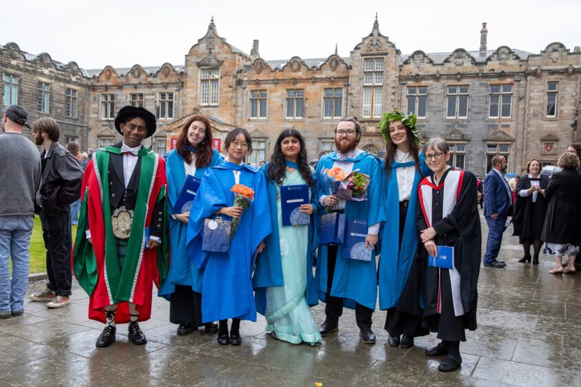 PhD English graduates pose for a group pic.