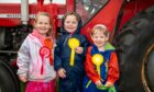 From L-R Lucy Matthews (5), Leah Phillips (5), and Lottie Matthews (2) with their ribbons from the kids running race. Image: Richard Hancox/DC Thomson