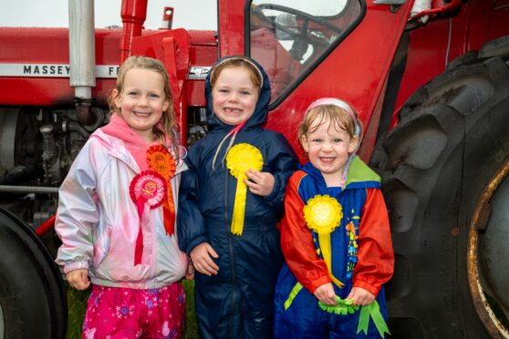 From L-R Lucy Matthews (5), Leah Phillips (5), and Lottie Matthews (2) with their ribbons from the kids running race. Image: Richard Hancox/DC Thomson