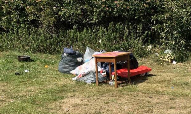 Several piles of rubbish left behind at Riverside Park, Dundee.