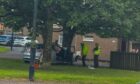 The aftermath of a car crash at Dalmahoy Drive, Dundee.