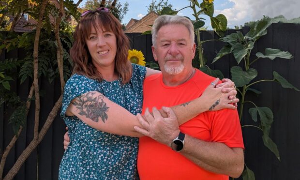 Laura Young with dad Mick Thompson after saving his life on a remote hillside.