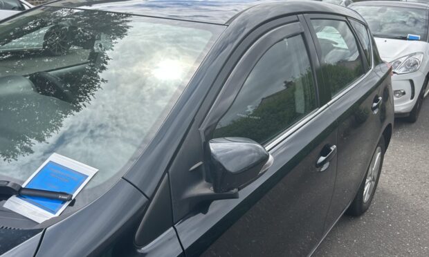 Dozens of pavement parking warning notices stuck on cars in Dunfermline.