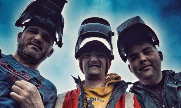 Three band members of Peat & Deisel