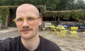 Jacob Smith smiling in front of the Gorse Café.