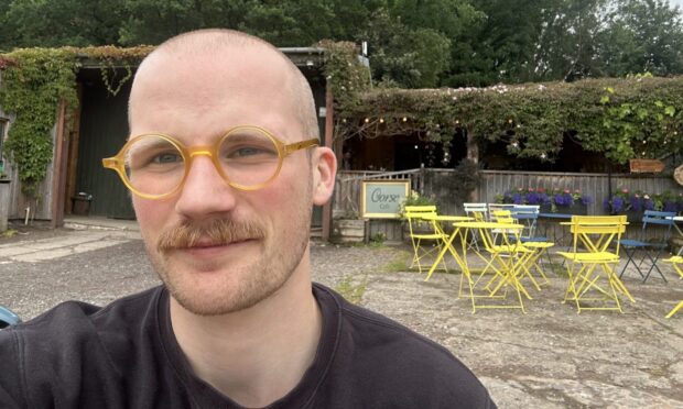 Jacob Smith smiling in front of the Gorse Café.