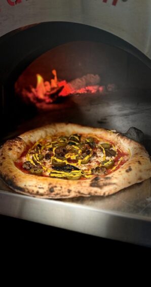A pizza in a wood-fired pizza oven.