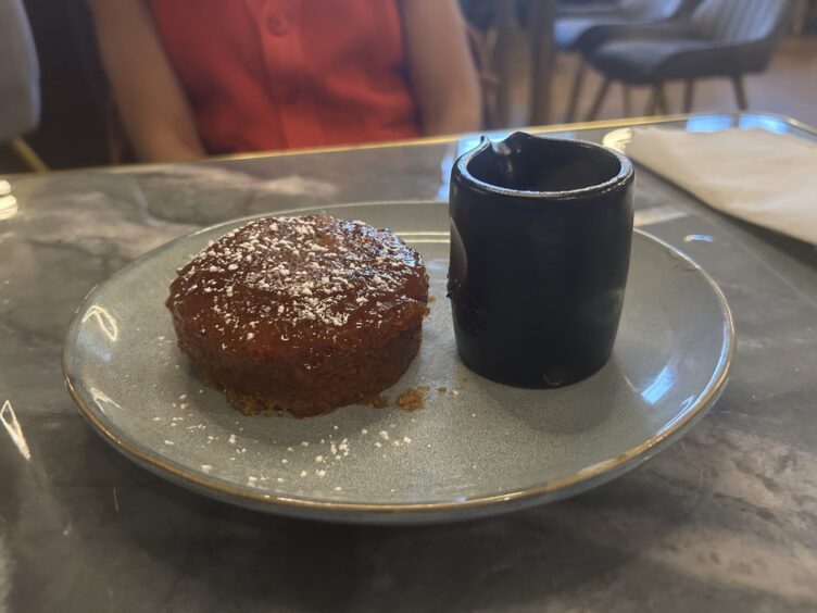 A dish of sticky toffee pudding.