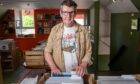 Colin Tennent rifling through crate of records at Foot of the Mountain Records shop