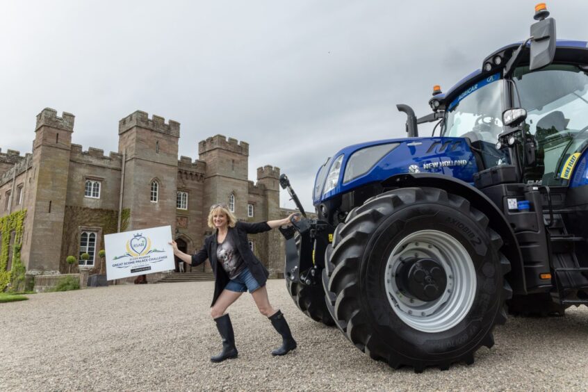 Nicola Wheeler in shorts and wellies pulling huge tractor in front of Scone Palace