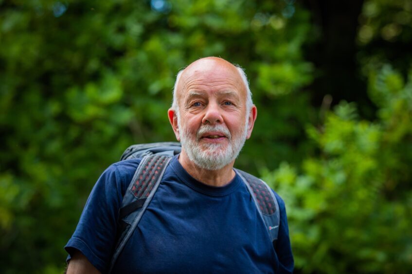 David Spaven in blue t shirt with rucksack on back