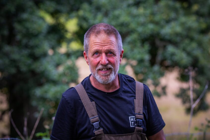 Pete Guile in navy shirt and dungarees