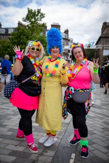 A woman in fancy dress as Marge Simpson celebrates a birthday with two friends at Dundee Discovery Festival.
