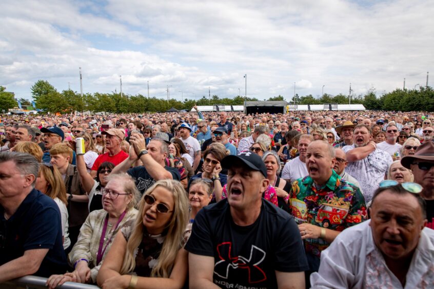 The large crowd at the Discovery Festival in Dundee singing along with the performers.