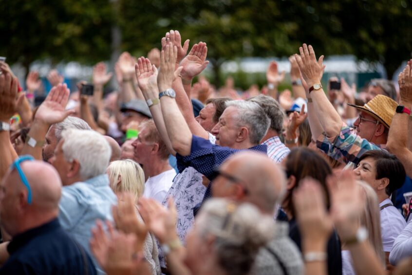 Fans clapping their hands to the beat at Dundee's Discovery Festival.
