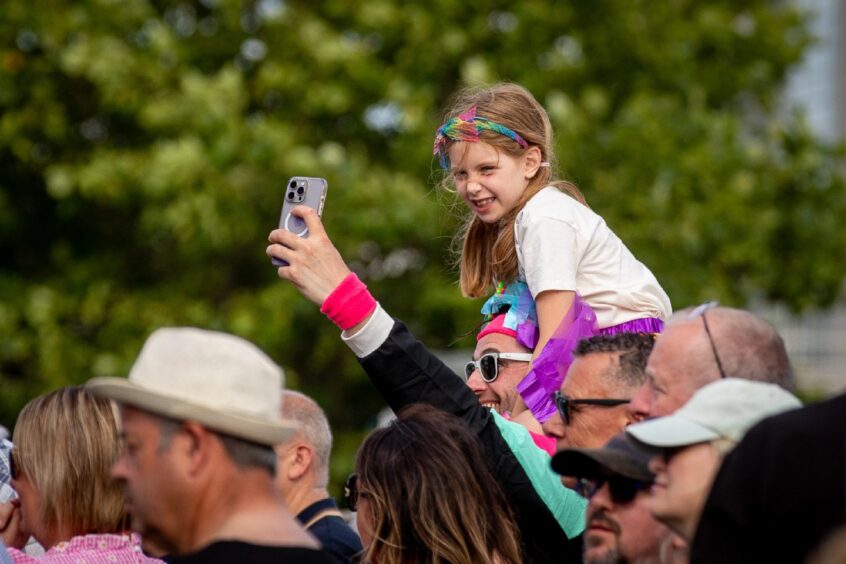 A young fan takes a better look at the acts on stage during Dundee's Discovery Festival.
