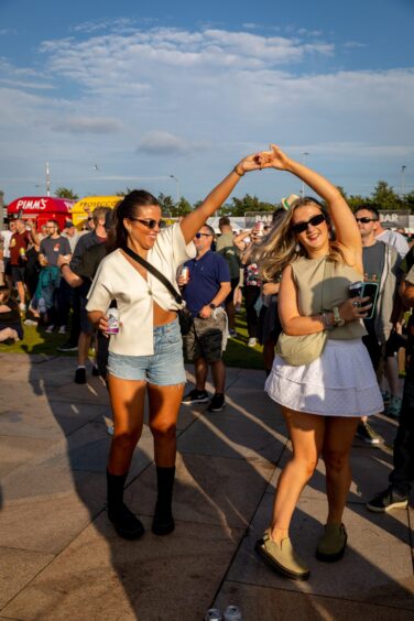 A pair of ladies dancing to White Lies.