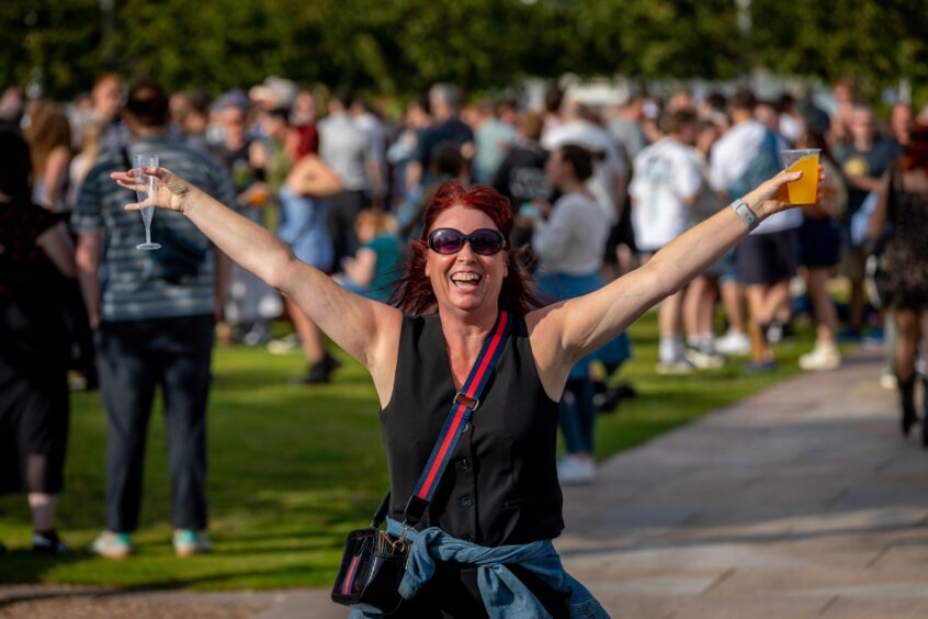 A woman shows off her delight at the Discovery Festival.