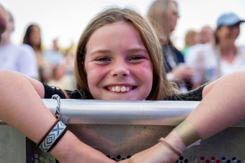 A young fan smiles at the festival.