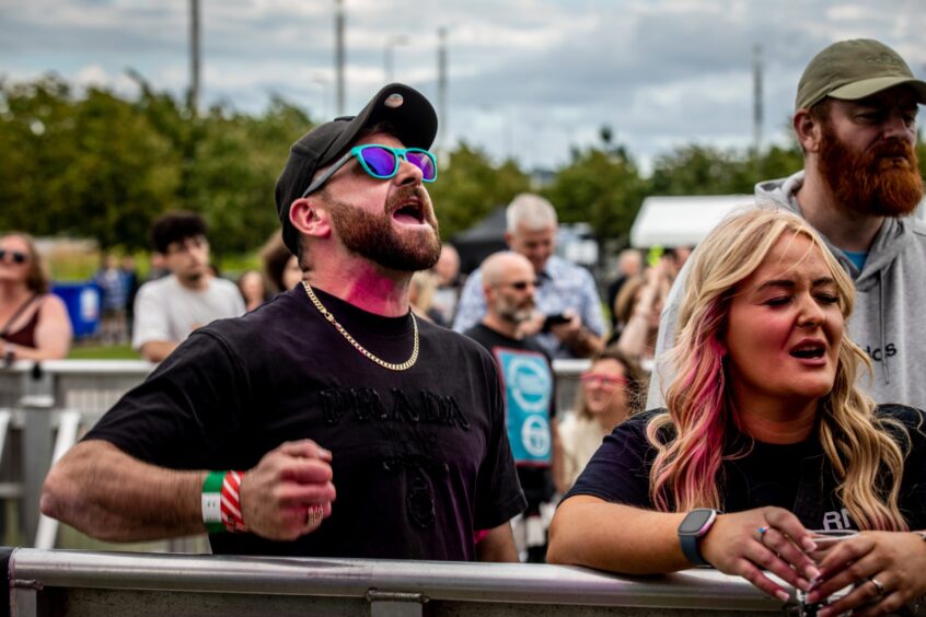 Crowd members singing along with the music at Dundee Discovery Festival.
