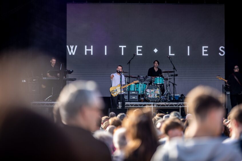 Indie rock band White Lies salute the crowds.