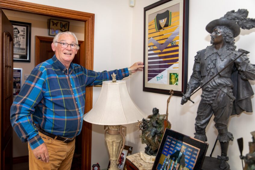 Jim Leishman at home with signed Nelson Mandela shirt.