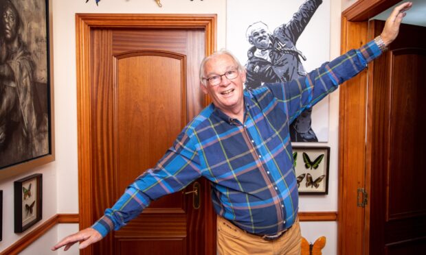 Jim Leishman recreates his famous 'Miracle on Tannadice Street' 'aeroplane' pose at home in Dunfermline.